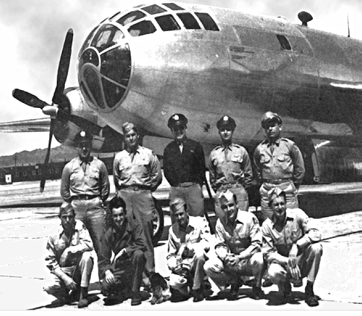 Crew posing in front of Bockscar before the atomic mission. Dehart is pictured on the far left in the front row.