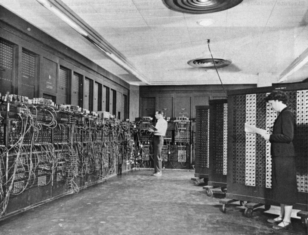 Glen Beck (background) and Betty Snyder (foreground) program ENIAC in BRL building 328. Photo courtesy of the U.S. Army.
