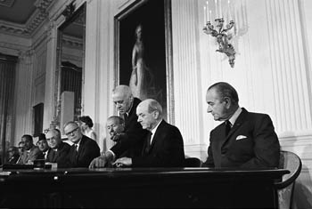 President Lyndon Johnson looking on as Secretary of State Dean Rusk prepares to sign the NPT, 1 July 1968. Photo Courtesy of the Lyndon B. Johnson Presidential Library.