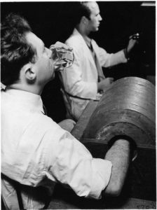 Joseph G. Hamilton drinking radiosodium for a demonstration, alongside Robert Marshak